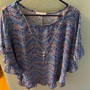 Blouse with necklace.